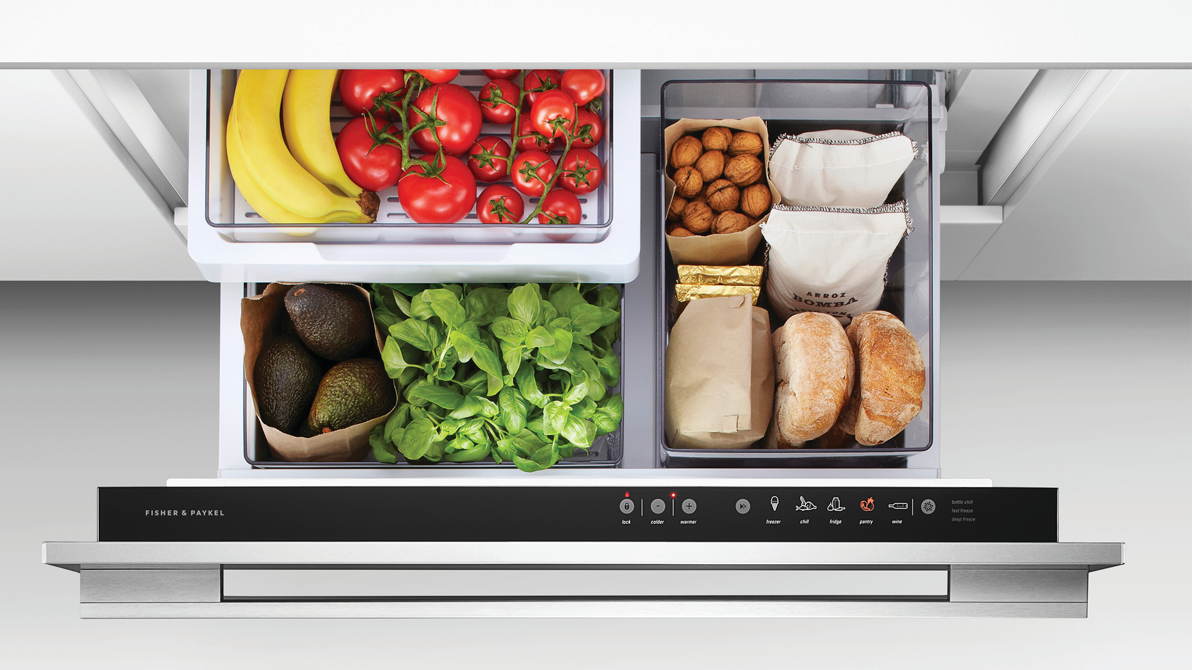 Open refrigeration drawer with fresh fruit, vegetables and bread in three different compartments.