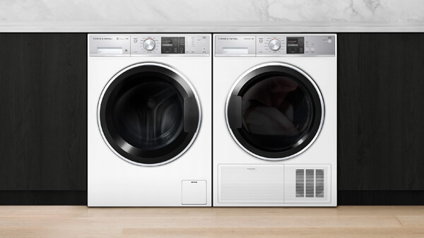 White Washing Machine & Dryer arranged Side-by-Side and set in Black Cabinetry